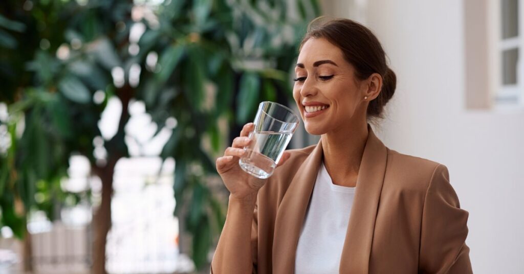 woman drinking clear water